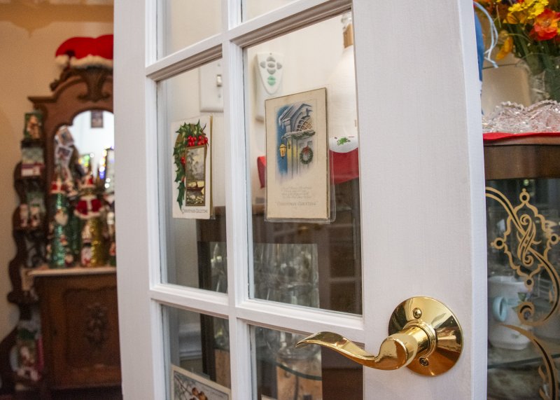 Vintage Christmas postcards adorn the interior doors at Lisa and Tom Malone’s West Shore Drive home.